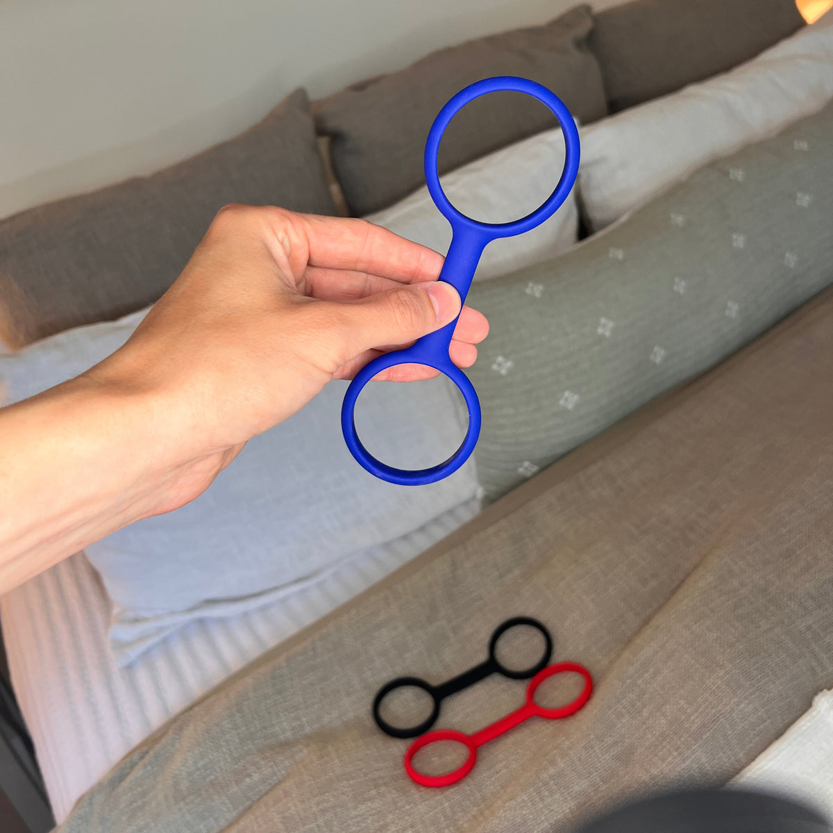 Esposas rubber handcuffs held in one hand